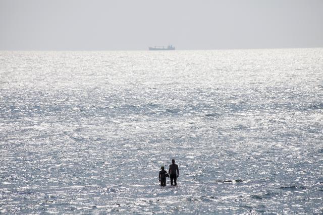 People enjoy the sun at the beach in the Black Sea in Odessa, Ukraine, Sunday, July 5, 2020. (AP)