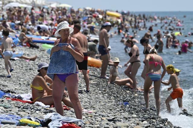 People enjoy the beach in the Black Sea resort of Sochi, Russia Sunday, July 5, 2020. (AP)