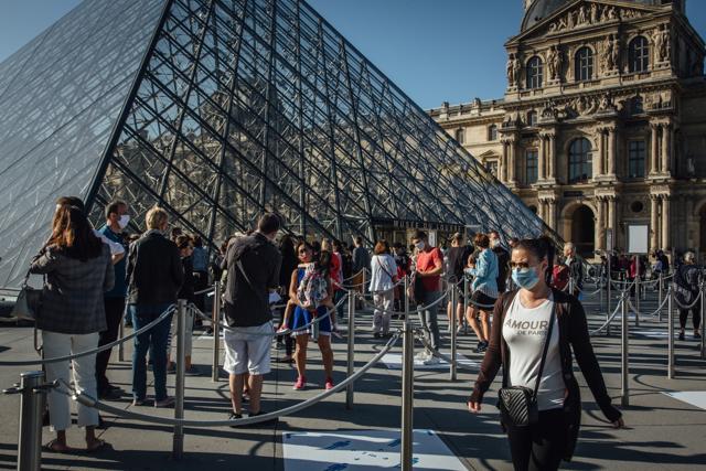 Visitors wearing protective face masks queue to enter the reopened Louvre Museum in Paris, France, on Monday, July 6, 2020. The Louvre had 9.6 million visitors last year. (Bloomberg) Visitors wearing protective face masks queue to enter the reopened Louvre Museum in Paris, France, on Monday, July 6, 2020. The Louvre had 9.6 million visitors last year. (Bloomberg)