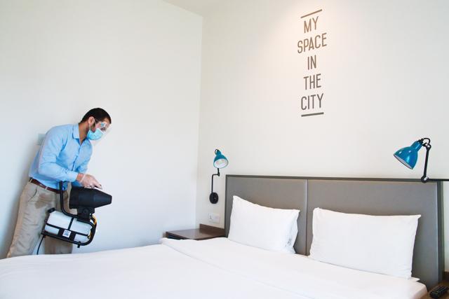 An employee wearing a mask due to the coronavirus pandemic fogs disinfectant in a hotel room at the Rove City Centre Hotel in Dubai, United Arab Emirates, Monday, July 6, 2020. (AP) An employee wearing a mask due to the coronavirus pandemic fogs disinfectant in a hotel room at the Rove City Centre Hotel in Dubai, United Arab Emirates, Monday, July 6, 2020. (AP)