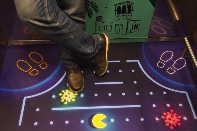 A man stands in an elevator decorated with a graphic showing the video game character Pac-Man eating the coronavirus at the Rove City Centre Hotel in Dubai, United Arab Emirates, Monday, July 6, 2020. (AP) A man stands in an elevator decorated with a graphic showing the video game character Pac-Man eating the coronavirus at the Rove City Centre Hotel in Dubai, United Arab Emirates, Monday, July 6, 2020. (AP)