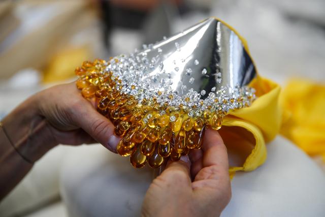A seamstress works on creations at the workshop of designer Stephane Rolland ahed of his Haute Couture Online Fall/winter 2020/2021 collection presentation in Paris, France, July 2, 2020. (REUTERS) A seamstress works on creations at the workshop of designer Stephane Rolland ahed of his Haute Couture Online Fall/winter 2020/2021 collection presentation in Paris, France, July 2, 2020. (REUTERS)