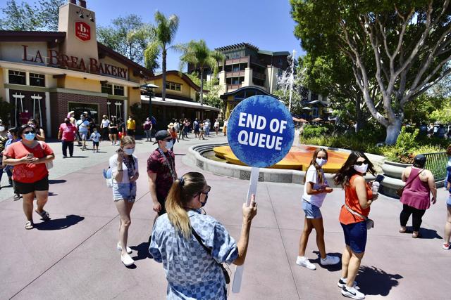 A Disney employee runs a line to get in to the virtual queue for World of Disney on the reopening day of the Downtown Disney District on its reopening day in Anaheim, Calif., Thursday, July 9, 2020. (AP) A Disney employee runs a line to get in to the virtual queue for World of Disney on the reopening day of the Downtown Disney District on its reopening day in Anaheim, Calif., Thursday, July 9, 2020. (AP)
