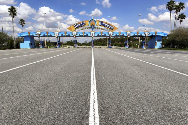 FILE - This March 24, 2020, file photo shows the parking plaza entrance to the Magic Kingdom as Walt Disney World enters its second week of being shut down in response to the coronavirus pandemic. Despite a huge surge of Floridians testing positive for the new coronavirus in recent weeks, Magic Kingdom and Animal Kingdom, two of Disney World's four parks are reopening Saturday, July 11. (AP) FILE - This March 24, 2020, file photo shows the parking plaza entrance to the Magic Kingdom as Walt Disney World enters its second week of being shut down in response to the coronavirus pandemic. Despite a huge surge of Floridians testing positive for the new coronavirus in recent weeks, Magic Kingdom and Animal Kingdom, two of Disney World's four parks are reopening Saturday, July 11. (AP)