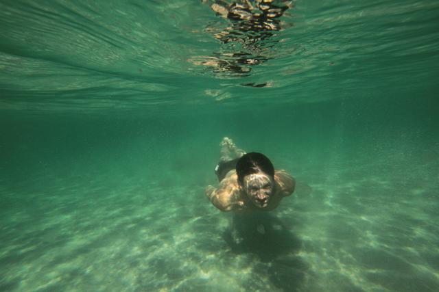 A man makes a dive while swimming in the waters of the Black Sea near the village of Vitino, Crimea July 4, 2020. (REUTERS) A man makes a dive while swimming in the waters of the Black Sea near the village of Vitino, Crimea July 4, 2020. (REUTERS)