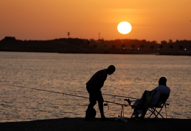 Vacationers fish during sunset at the Red Sea beach, in Jiddah, Saudi Arabia, Thursday, July 9, 2020. (AP) Vacationers fish during sunset at the Red Sea beach, in Jiddah, Saudi Arabia, Thursday, July 9, 2020. (AP)