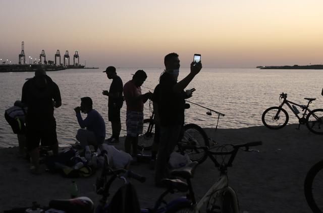 Vacationers gather for food and drinks during sunset at the Red Sea beach after the government eases the coronavirus lockdown restrictions in Jiddah, Saudi Arabia, Thursday, July 9, 2020. (AP) Vacationers gather for food and drinks during sunset at the Red Sea beach after the government eases the coronavirus lockdown restrictions in Jiddah, Saudi Arabia, Thursday, July 9, 2020. (AP)