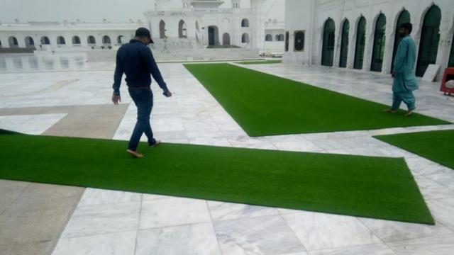 Photos tweeted by the Pakistan Sikh Gurdwara Parbandhak Committee showing the astroturf spread out for the convenience of pilgrims on the marble floor at Kartarpur Sahib gurdwara due to the hot weather. (Twitter)
