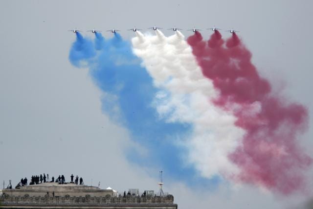 Paris: Guests watch form the top of the Arc de Triomphe the French Alpha jets of the Patrouille de France flying over the Champs Elysees avenue during the Bastille Day military parade, Tuesday, July 14, 2020 in Paris. (AP) Paris: Guests watch form the top of the Arc de Triomphe the French Alpha jets of the Patrouille de France flying over the Champs Elysees avenue during the Bastille Day military parade, Tuesday, July 14, 2020 in Paris. (AP)