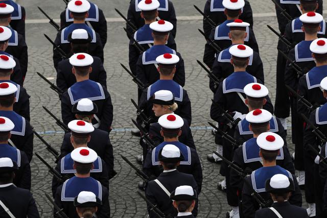France's marine soldiers wait before the start of the Bastille Day military parade, Tuesday, July 14, 2020 in Paris. France are honouring nurses, ambulance drivers, supermarket cashiers and others on its biggest national holiday Tuesday. Bastille Day's usual grandiose military parade in Paris is being redesigned this year to celebrate heroes of the coronavirus pandemic. (AP) France's marine soldiers wait before the start of the Bastille Day military parade, Tuesday, July 14, 2020 in Paris. France are honouring nurses, ambulance drivers, supermarket cashiers and others on its biggest national holiday Tuesday. Bastille Day's usual grandiose military parade in Paris is being redesigned this year to celebrate heroes of the coronavirus pandemic. (AP)