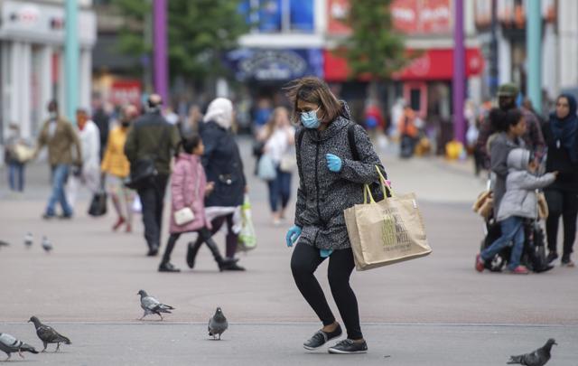 A shopper wearing a face mask on Humberstone Gate in Leicester, England, Monday June 29, 2020. (AP) A shopper wearing a face mask on Humberstone Gate in Leicester, England, Monday June 29, 2020. (AP)