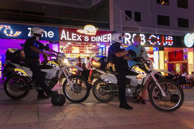 Police officers patrol as tourists stand in a terrace at the resort of Magaluf on the Spanish Balearic island of Mallorca, Spain, Thursday, July 16, 2020. Authorities in Spain's Balearic Islands are pulling the plug on endless drunken nights to the beat of techno music by closing bars and nightclubs in beachfront areas popular with young and foreign visitors. (AP) Police officers patrol as tourists stand in a terrace at the resort of Magaluf on the Spanish Balearic island of Mallorca, Spain, Thursday, July 16, 2020. Authorities in Spain's Balearic Islands are pulling the plug on endless drunken nights to the beat of techno music by closing bars and nightclubs in beachfront areas popular with young and foreign visitors. (AP)
