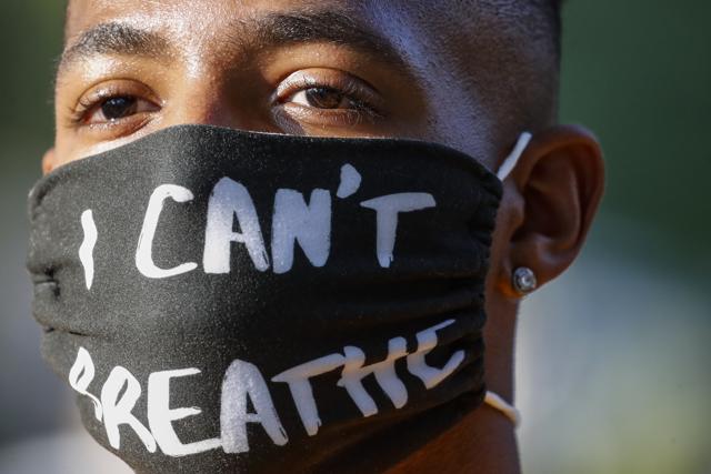 A protester wears a protective mask during a Black Lives Matter march through a residential neighbourhood calling for racial justice, Monday, July 13, 2020, in Valley Stream, N.Y. (AP) A protester wears a protective mask during a Black Lives Matter march through a residential neighbourhood calling for racial justice, Monday, July 13, 2020, in Valley Stream, N.Y. (AP)