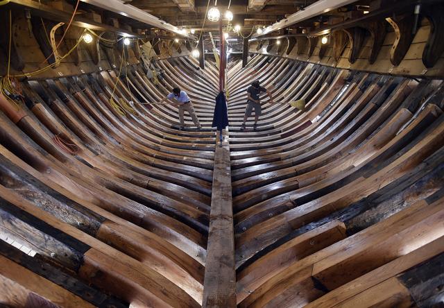 FILE- In this Nov. 3, 2017 file photo, shipwrights Jamie Kirschner, left, and Tucker Yaro, clean out the hold of the Mayflower II at Mystic Seaport in Mystic, Conn. (AP) FILE- In this Nov. 3, 2017 file photo, shipwrights Jamie Kirschner, left, and Tucker Yaro, clean out the hold of the Mayflower II at Mystic Seaport in Mystic, Conn. (AP)
