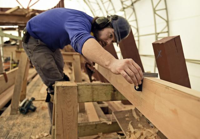 FILE- In this Feb. 21, 2019 file photo, shipwright Mike Brittan checks his work as he planes a deck plank for the main deck of the Mayflower II at the Mystic Seaport in Mystic, Conn. The Mayflower II is set to leave Mystic Seaport on Monday, July 20, 2020, for a sea trials in New London, Conn., before sailing up the coast and arriving at Plimoth Plantation in Massachusetts during the second week of August 2020. (AP) FILE- In this Feb. 21, 2019 file photo, shipwright Mike Brittan checks his work as he planes a deck plank for the main deck of the Mayflower II at the Mystic Seaport in Mystic, Conn. The Mayflower II is set to leave Mystic Seaport on Monday, July 20, 2020, for a sea trials in New London, Conn., before sailing up the coast and arriving at Plimoth Plantation in Massachusetts during the second week of August 2020. (AP)