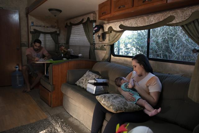 Magician Daniela Portugal breast-fed her 4-month baby before performing at the Estoril Circus in a drive-in format, amid the new coronavirus pandemic in Itaguai, greater Rio de Janeiro, Brazil, Saturday, July 18, 2020. Portugal had his baby at the same period that the pandemic reached the country. (AP) Magician Daniela Portugal breast-fed her 4-month baby before performing at the Estoril Circus in a drive-in format, amid the new coronavirus pandemic in Itaguai, greater Rio de Janeiro, Brazil, Saturday, July 18, 2020. Portugal had his baby at the same period that the pandemic reached the country. (AP)