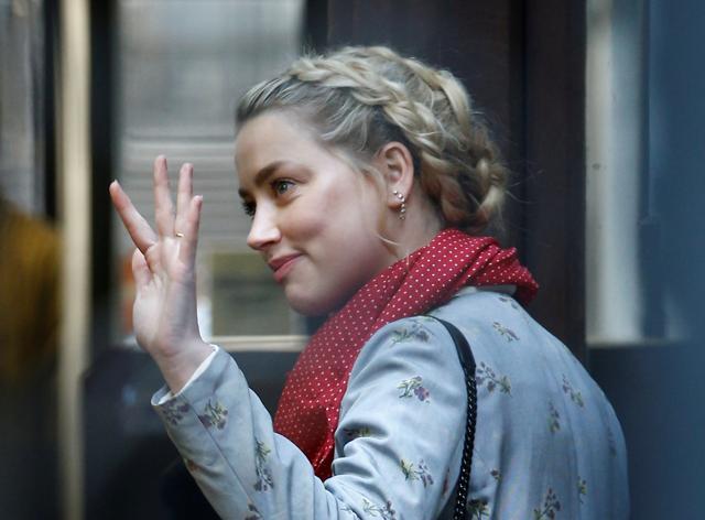 Actor Amber Heard waves as she arrives at the High Court in London, Britain. (REUTERS) Actor Amber Heard waves as she arrives at the High Court in London, Britain. (REUTERS)