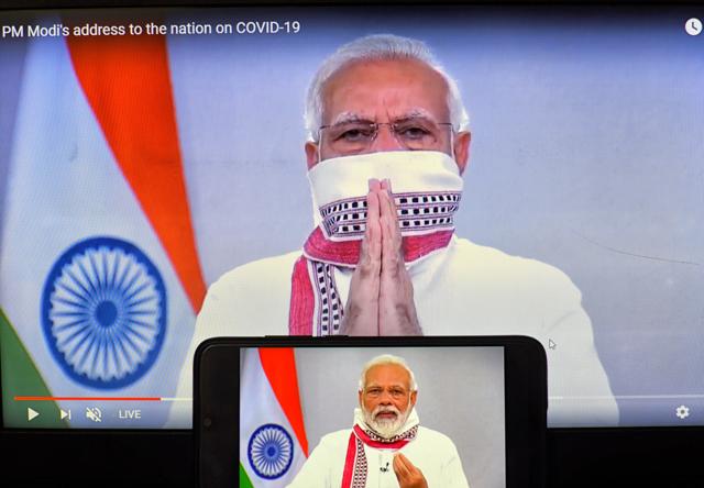 Prime Minister Narendra Modi seen on a smartphone and screen announcing extension of the lockdown up to 3rd May 2020 as a preventive measure against the spread of Coronavirus. (Avishek Das/Sipa USA via AP Images) Prime Minister Narendra Modi seen on a smartphone and screen announcing extension of the lockdown up to 3rd May 2020 as a preventive measure against the spread of Coronavirus. (Avishek Das/Sipa USA via AP Images)