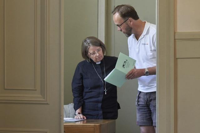 Rev. Elisabeth Oberg Hansen of the Church of Sweden reviews the service planned by her student Rikard Kjellman ahead of his first sermon in Stockholm, Thursday, July 23, 2020. (AP) Rev. Elisabeth Oberg Hansen of the Church of Sweden reviews the service planned by her student Rikard Kjellman ahead of his first sermon in Stockholm, Thursday, July 23, 2020. (AP)