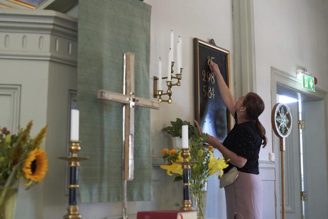 A church assistant installs number on a hymn board ahead of a sermon in Stockholm, Thursday, July 23, 2020. (AP) A church assistant installs number on a hymn board ahead of a sermon in Stockholm, Thursday, July 23, 2020. (AP)