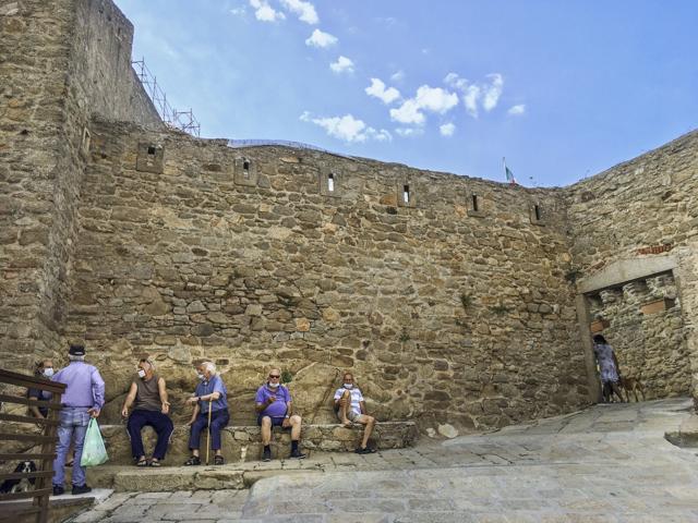 Residents of Giglio island socialize in the steep alleys near the port or on the granite steps that serve as narrow streets in the hilltop Castle neighbourhood, with densely packed homes built against the remnants of a fortress that centuries ago served as protection against pirates. (AP Photo/Paolo Santalucia) Residents of Giglio island socialize in the steep alleys near the port or on the granite steps that serve as narrow streets in the hilltop Castle neighbourhood, with densely packed homes built against the remnants of a fortress that centuries ago served as protection against pirates. (AP Photo/Paolo Santalucia)