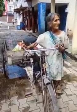 The woman collects garbage to be able to look after her son The woman collects garbage to be able to look after her son