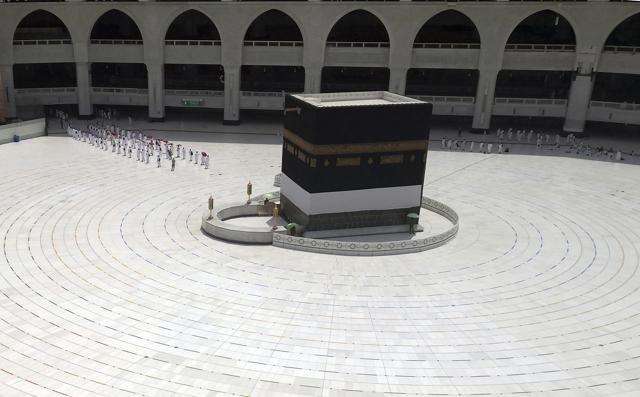 Muslim pilgrims line up as they leave after they circumambulate around the Kaaba, the cubic building at the Grand Mosque, as they keep social destination to protect themselves against Coronavirus ahead of the Hajj pilgrimage in the Muslim holy city of Mecca, Saudi Arabia, Wednesday, July 29, 2020. (AP) Muslim pilgrims line up as they leave after they circumambulate around the Kaaba, the cubic building at the Grand Mosque, as they keep social destination to protect themselves against Coronavirus ahead of the Hajj pilgrimage in the Muslim holy city of Mecca, Saudi Arabia, Wednesday, July 29, 2020. (AP)