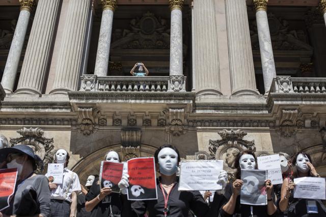 French tourist guides stage a protest regarding the impact on their sector due to the coronavirus outbreak, outside the Opera Garnier in Paris, France, Thursday, July 30, 2020. Tourism operators across Asia and Europe are making furtive and faltering advances, as well as some spectacular missteps, after travel was largely halted by the coronavirus pandemic that continues ebbing and mostly surging around the globe. (AP) French tourist guides stage a protest regarding the impact on their sector due to the coronavirus outbreak, outside the Opera Garnier in Paris, France, Thursday, July 30, 2020. Tourism operators across Asia and Europe are making furtive and faltering advances, as well as some spectacular missteps, after travel was largely halted by the coronavirus pandemic that continues ebbing and mostly surging around the globe. (AP)