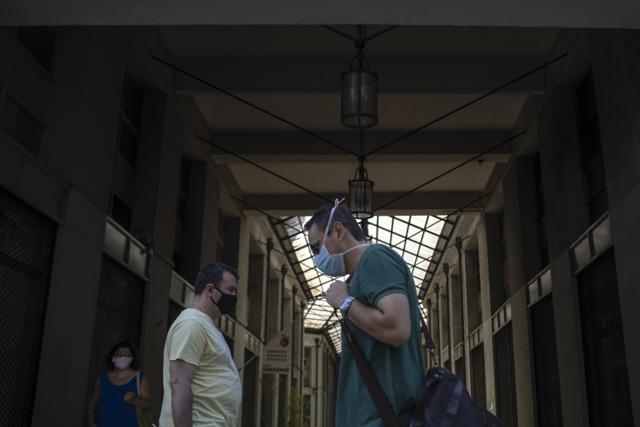 Pedestrians wearing face masks walk in Athens, on Tuesday, Aug. 4, 2020. Greek authorities introduced tougher restrictions the last days following an increase in infections. (AP) Pedestrians wearing face masks walk in Athens, on Tuesday, Aug. 4, 2020. Greek authorities introduced tougher restrictions the last days following an increase in infections. (AP)