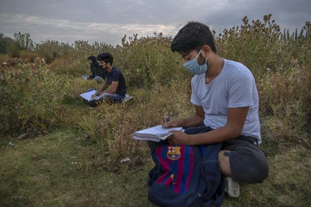 Kashmiri students attend an open-air early morning classes inside Eidgah or ground reserved for Eid prayers in Srinagar, Indian controlled Kashmir, Friday, July 18, 2020. When months went by without teaching, Muneer Alam, an engineer-turned-math teacher, started the informal community school in the form of an open-air classroom in June. Schools in the disputed region reopened after six months in late February, after a strict lockdown that began in August 2019, when India scrapped the region’s semi-autonomous status. In March schools were shut again because of the coronavirus pandemic. (AP) Kashmiri students attend an open-air early morning classes inside Eidgah or ground reserved for Eid prayers in Srinagar, Indian controlled Kashmir, Friday, July 18, 2020. When months went by without teaching, Muneer Alam, an engineer-turned-math teacher, started the informal community school in the form of an open-air classroom in June. Schools in the disputed region reopened after six months in late February, after a strict lockdown that began in August 2019, when India scrapped the region’s semi-autonomous status. In March schools were shut again because of the coronavirus pandemic. (AP)