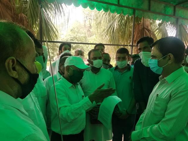 Haryana Congress treasurer Rohit Jain (in cap) meeting DC Ashok Kumar Sharma (extreme right) in his office. (HT Photo) Haryana Congress treasurer Rohit Jain (in cap) meeting DC Ashok Kumar Sharma (extreme right) in his office. (HT Photo)