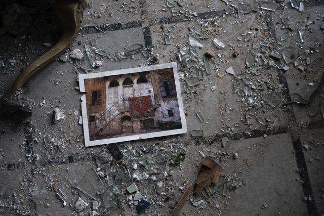 A photo rests among broken glass on the floor of the Sursock Palace, heavily damaged after the explosion in the seaport of Beirut, Lebanon, Friday, Aug. 7, 2020. (AP Photo/Felipe Dana) A photo rests among broken glass on the floor of the Sursock Palace, heavily damaged after the explosion in the seaport of Beirut, Lebanon, Friday, Aug. 7, 2020. (AP Photo/Felipe Dana)