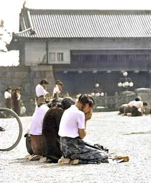 In this black and white Kyodo News photo digitally colourized and published in 2020 by Anju Niwata and Hidenori Watanave, three Japanese schoolgirls are seen weeping in front of Japanese Emperor Hirohito's palace, on Imperial Plaza in Tokyo, on Aug. 15, 1945. (AP) In this black and white Kyodo News photo digitally colourized and published in 2020 by Anju Niwata and Hidenori Watanave, three Japanese schoolgirls are seen weeping in front of Japanese Emperor Hirohito's palace, on Imperial Plaza in Tokyo, on Aug. 15, 1945. (AP)