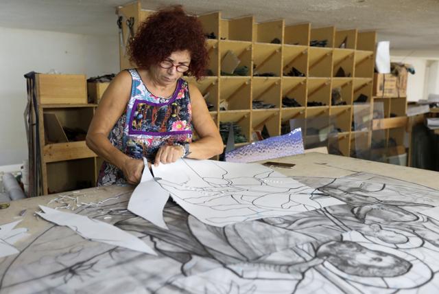 Stained glass maker Maya Husseini works inside her workshop in Hazmiyeh, Lebanon August 13, 2020. (REUTERS)