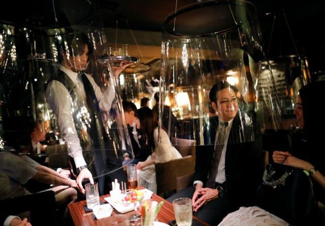 Both customers and staff are seen with the the goldfish bowl-like acrylic screens. (REUTERS) Both customers and staff are seen with the the goldfish bowl-like acrylic screens. (REUTERS)