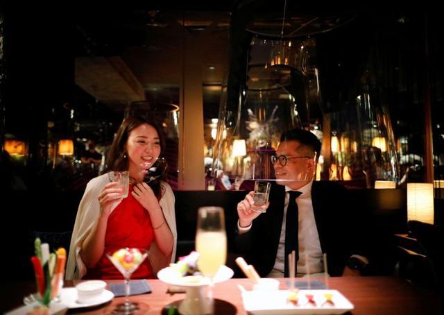 Customers enjoy themselves while sitting inside the screen. (REUTERS) Customers enjoy themselves while sitting inside the screen. (REUTERS)
