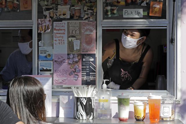 Kaye Fan, right, calls out orders as she works in her Dreamy Drinks food truck, Monday, Aug. 10, 2020, near the suburb of Lynnwood, Wash., north of Seattle. (AP)