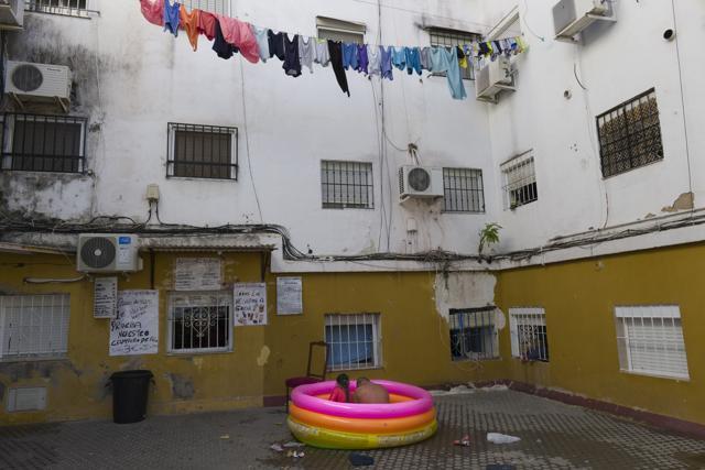 Two people sit in a plastic pool in Seville, Spain. (AP) Two people sit in a plastic pool in Seville, Spain. (AP)