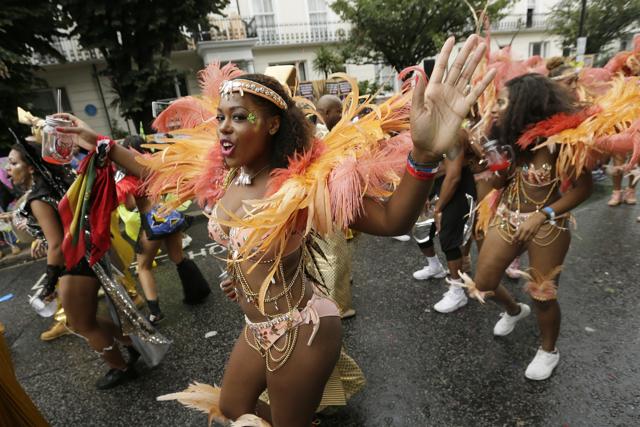 In this Monday, Aug. 31, 2015 file photo, a costumed reveller performs in the Notting Hill Carnival in London. (AP Photo/Tim Ireland, File) In this Monday, Aug. 31, 2015 file photo, a costumed reveller performs in the Notting Hill Carnival in London. (AP Photo/Tim Ireland, File)