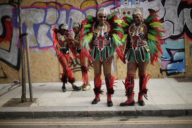In this Monday, Aug. 27, 2018 file photo, costumed revellers pose ahead of the parade during the Notting Hill Carnival in London. (AP Photo/Tim Ireland, File) In this Monday, Aug. 27, 2018 file photo, costumed revellers pose ahead of the parade during the Notting Hill Carnival in London. (AP Photo/Tim Ireland, File)