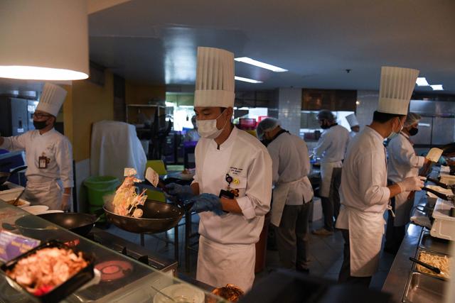 Japanese chef Jun Uenishi cooks at a pop-up airplane-themed restaurant at the Thai Airways headquarters with onboard meals prepared by their chefs, while their fleet is still grounded at the airport and the company awaits a bankruptcy court decision, in Bangkok, Thailand September 3, 2020. (REUTERS)