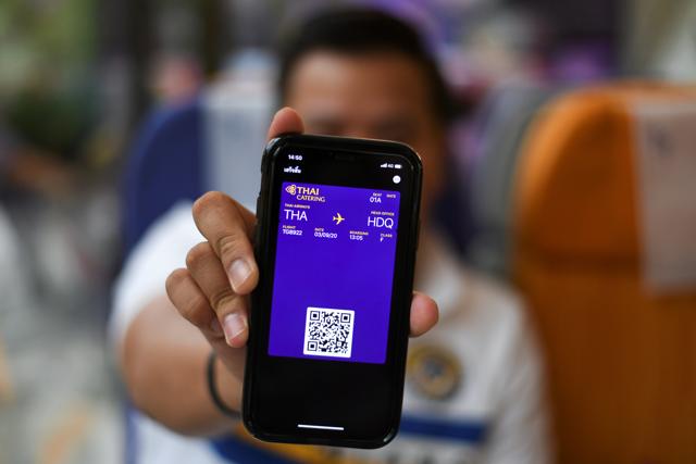 A customer shows a "special boarding pass" needed to enter the Thai Airways pop-up airplane-themed restaurant at the airlines headquarters with onboard meals prepared by their chefs, while their fleet is still grounded at the airport and the company awaits a bankruptcy court decision, in Bangkok, Thailand September 3, 2020. (REUTERS)