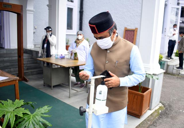 Health minister Rajiv Saizal sanitising his hands at the assembly gate in Shimla on Monday. (HT Photo ) Health minister Rajiv Saizal sanitising his hands at the assembly gate in Shimla on Monday. (HT Photo )