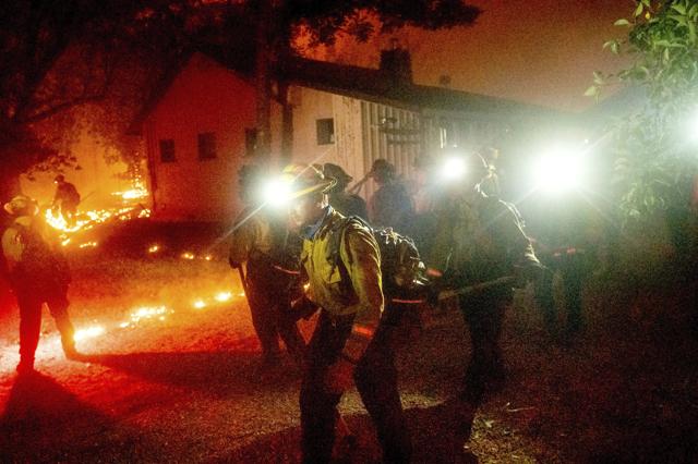A hand crew works to save a home as the Bear Fire burns through the Berry Creek area of Butte County, Calif., on Wednesday, Sept. 9, 2020. (AP) A hand crew works to save a home as the Bear Fire burns through the Berry Creek area of Butte County, Calif., on Wednesday, Sept. 9, 2020. (AP)