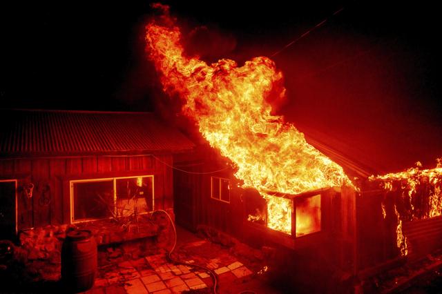 Flames shoot from a window as the Bear Fire burns through the Berry Creek area of Butte County, Calif., on Wednesday, Sept. 9, 2020. (AP) Flames shoot from a window as the Bear Fire burns through the Berry Creek area of Butte County, Calif., on Wednesday, Sept. 9, 2020. (AP)