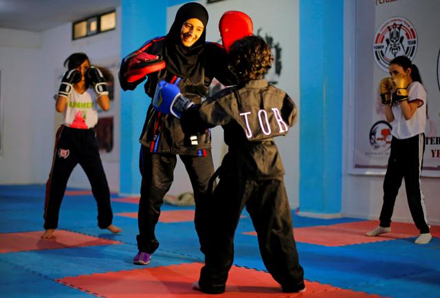 Martial arts trainer Seham Amer practices self-defense moves with a trainee at a training center in Sanaa, Yemen September 1, 2020. (REUTERS) Martial arts trainer Seham Amer practices self-defense moves with a trainee at a training center in Sanaa, Yemen September 1, 2020. (REUTERS)