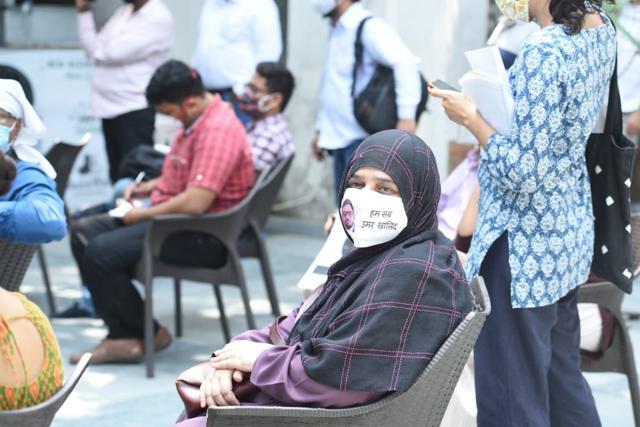 Those present at the gathering, including Khalid’s mother, wore masks with faces of arrested student activists. (Arvind Yadav/HT Photo) Those present at the gathering, including Khalid’s mother, wore masks with faces of arrested student activists. (Arvind Yadav/HT Photo)