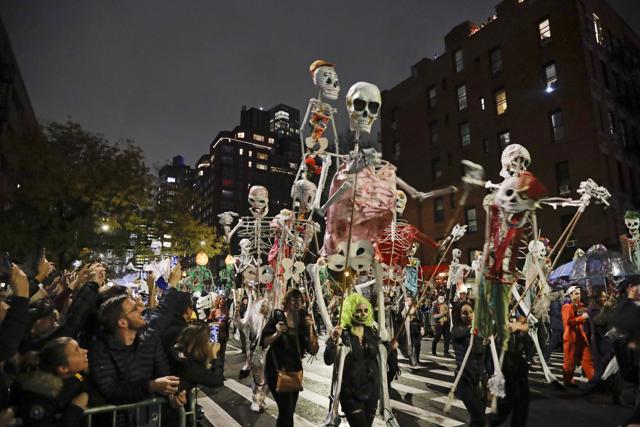 FILE - Revelers march during the Greenwich Village Halloween Parade in New York on Oct. 31, 2019. The holiday so many look forward to each year is going to look different in the pandemic as parents and the people who provide Halloween fun navigate a myriad of restrictions and safety concerns. (AP)