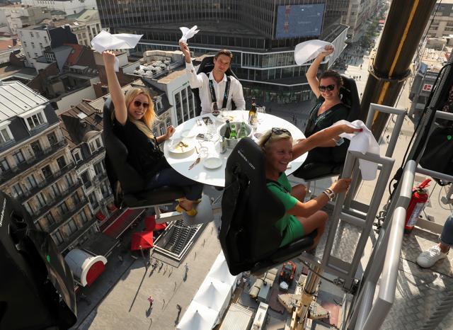 People sit at one of the eight tables. (REUTERS) People sit at one of the eight tables. (REUTERS)