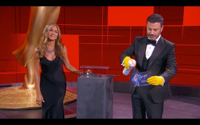 This handout screen shot released courtesy of American Broadcasting Companies, Inc. / ABC shows host Jimmy Kimmel and actress Jennifer Aniston disinfecting ballots during the 72nd Primetime Emmy Awards ceremony held virtually on September 20, 2020. (AFP) This handout screen shot released courtesy of American Broadcasting Companies, Inc. / ABC shows host Jimmy Kimmel and actress Jennifer Aniston disinfecting ballots during the 72nd Primetime Emmy Awards ceremony held virtually on September 20, 2020. (AFP)